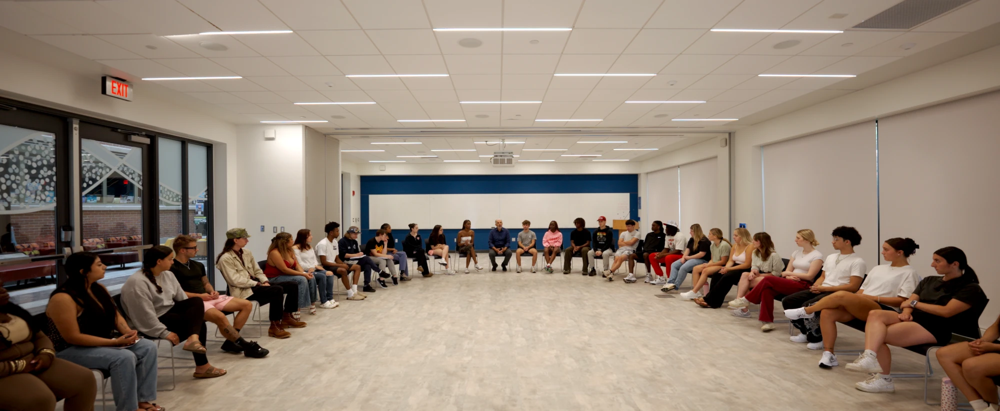 Matthew Warshauer and his students seated in a wide circle in a classroom